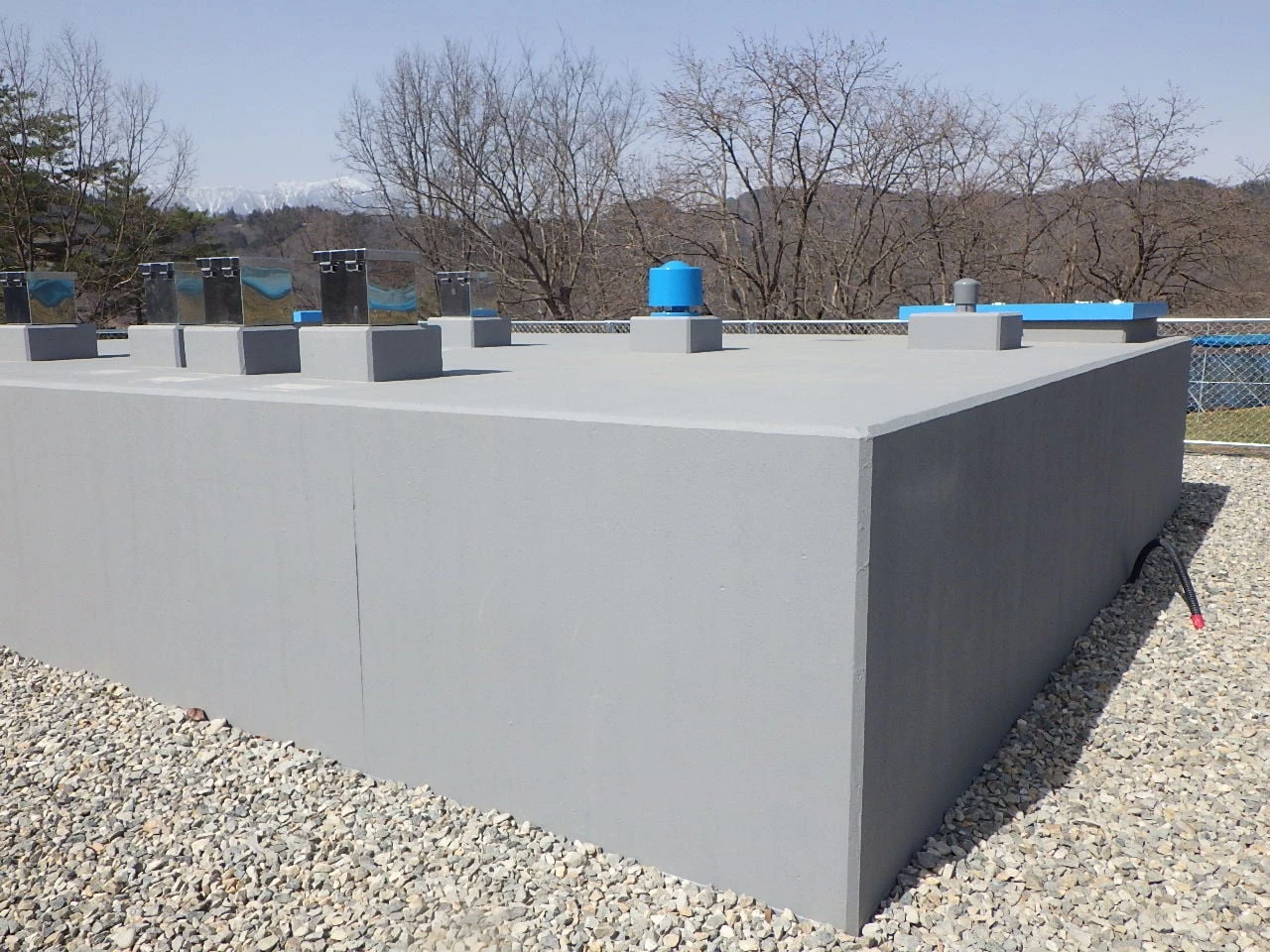 完成した配水池の外観。躯体の上に点検口と通気管が並ぶ