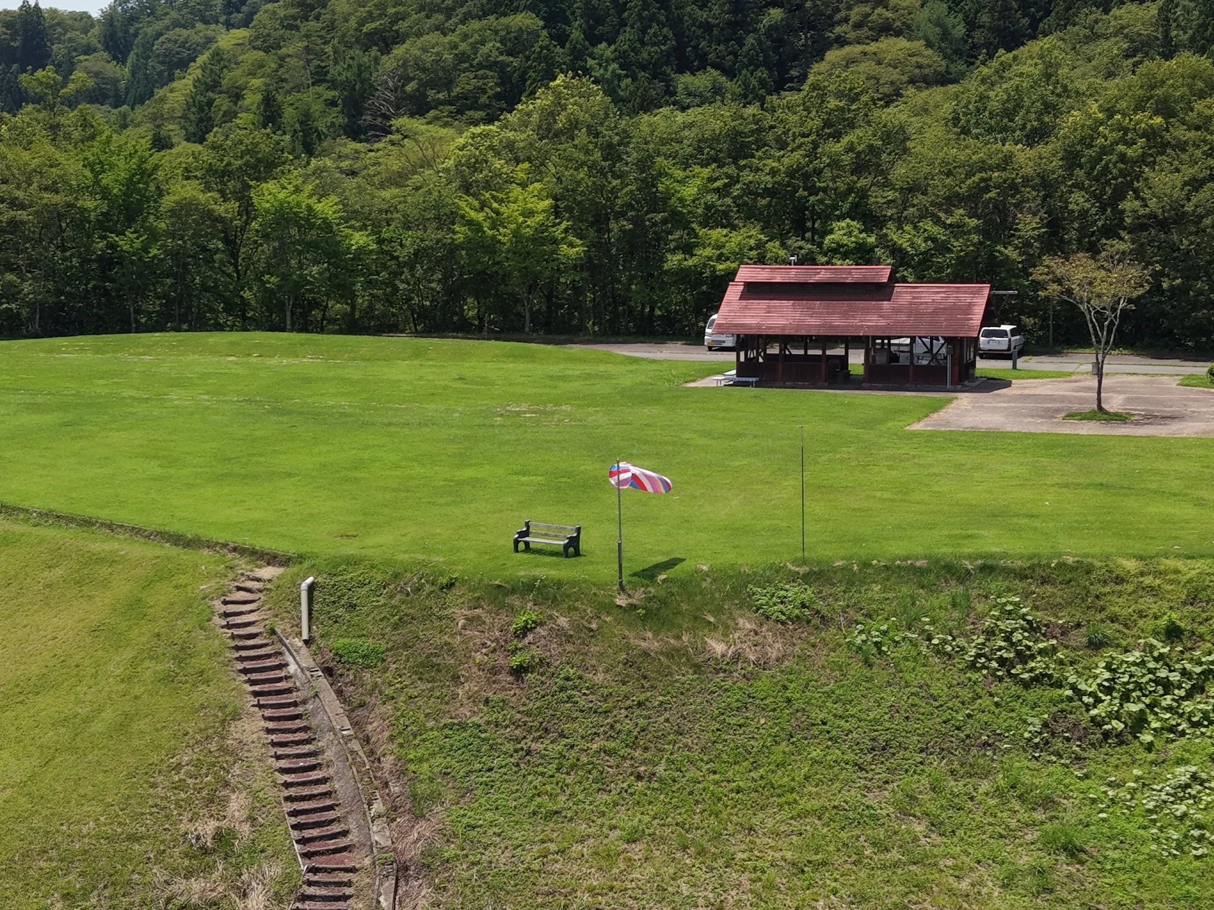 上空から見た芝生の広場と赤い屋根の建物